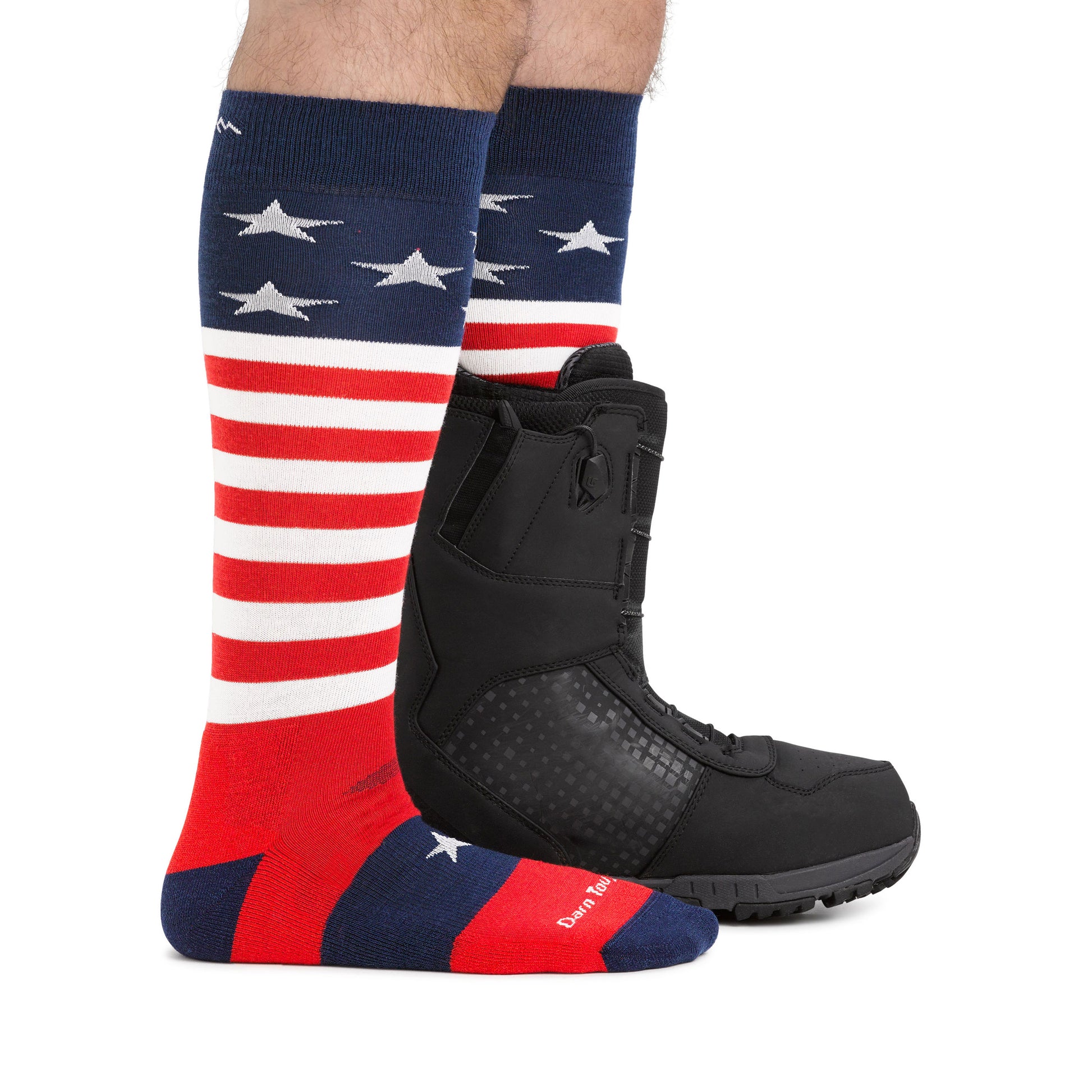 Darn Tough Stars and stripes socks on model wearing a snowboard boot