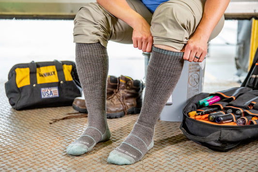 Women's Darn Tough 2201 Over the calf work socks in shale on model