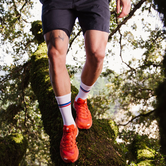 Darn Tough 1103 white socks on model walking outdoors