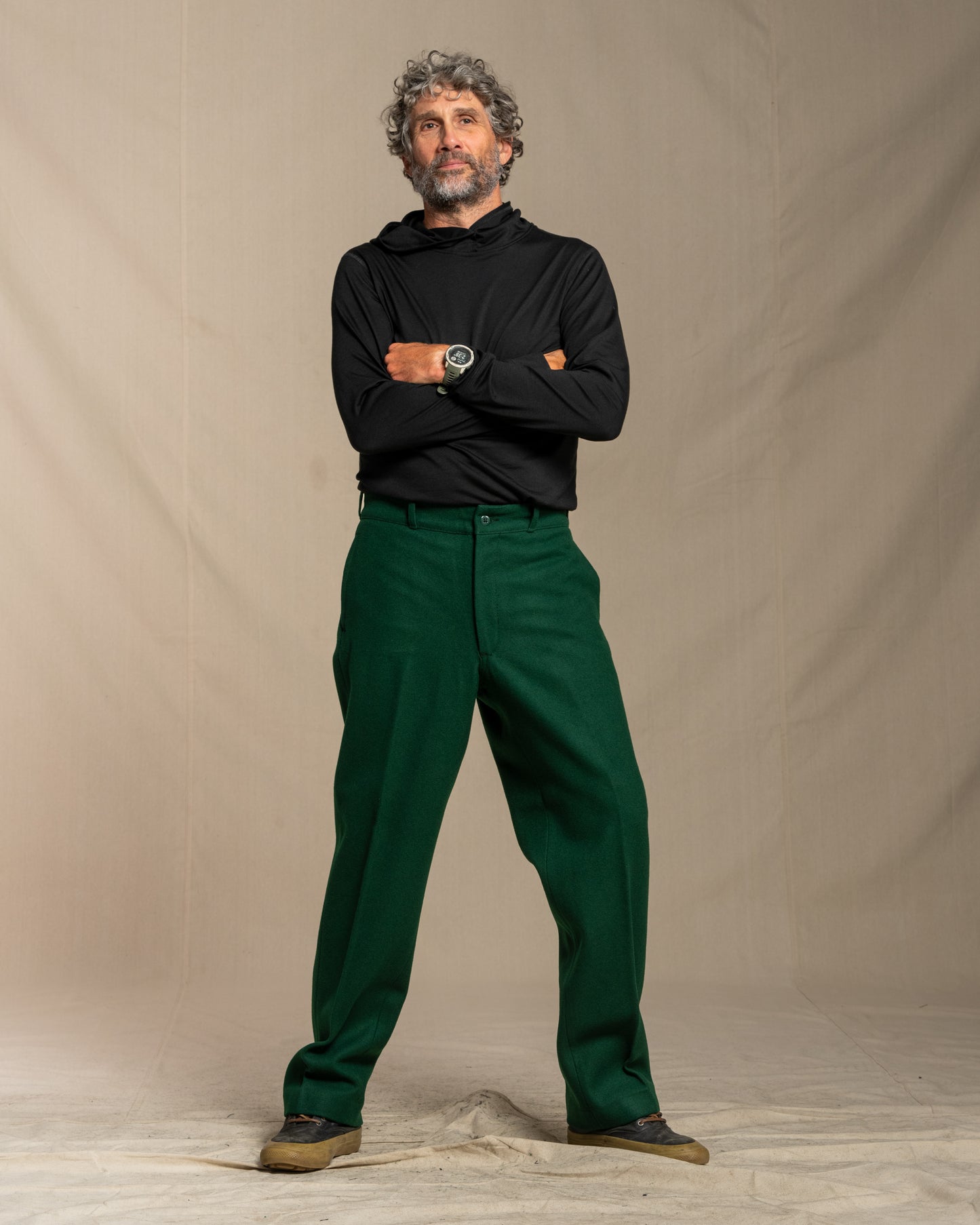 Green wool pants worn by a person on a canvas background
