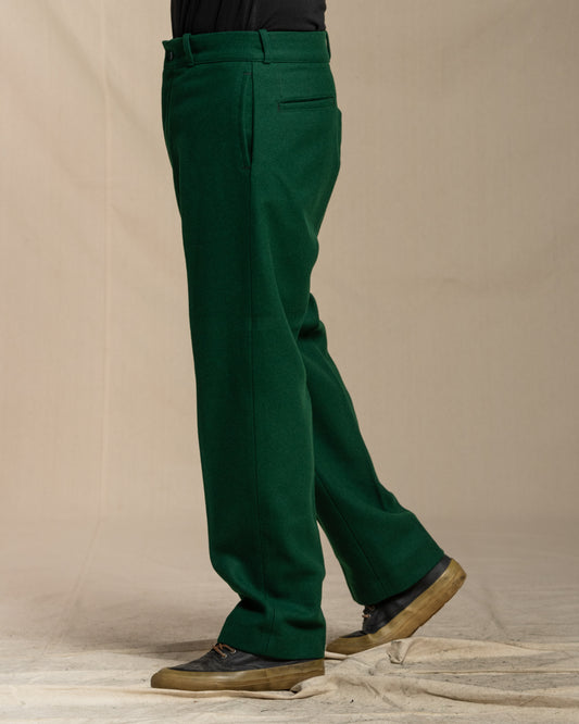 Green wool pants worn by a person on a canvas background