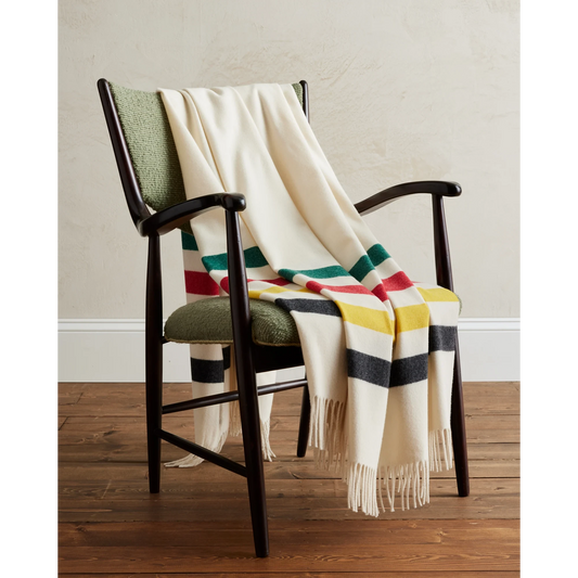 Pendleton 5th Avenue Merino Wool Glacier Park Throw laying on chair