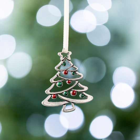 Decorative Christmas tree ornament with colored beads against a blurred green and white light background