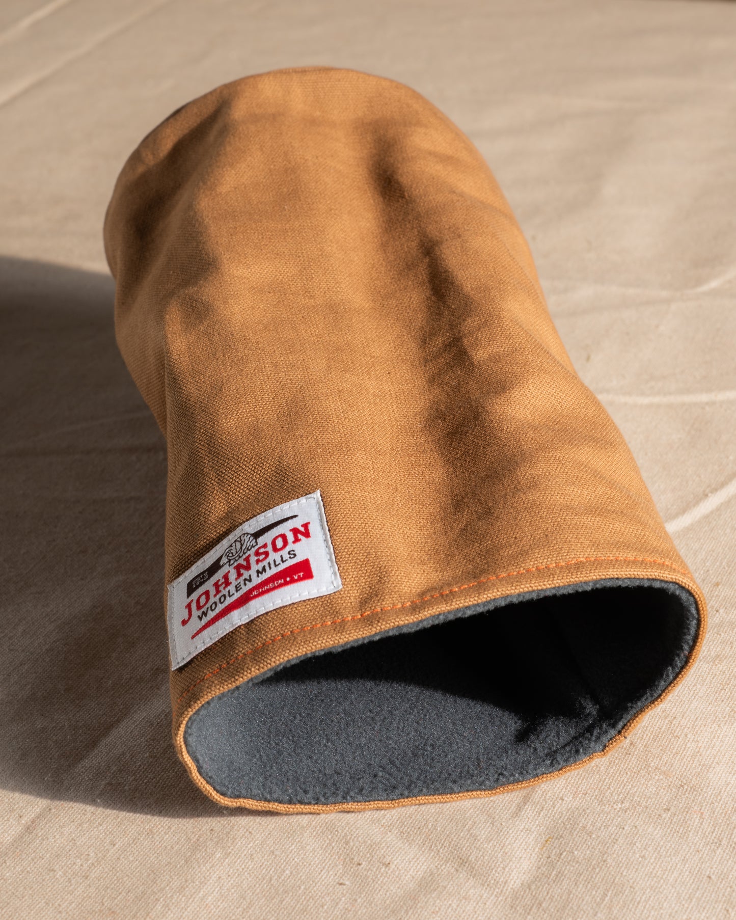 Brown canvas driver headcover with a Johnson logo on a beige background
