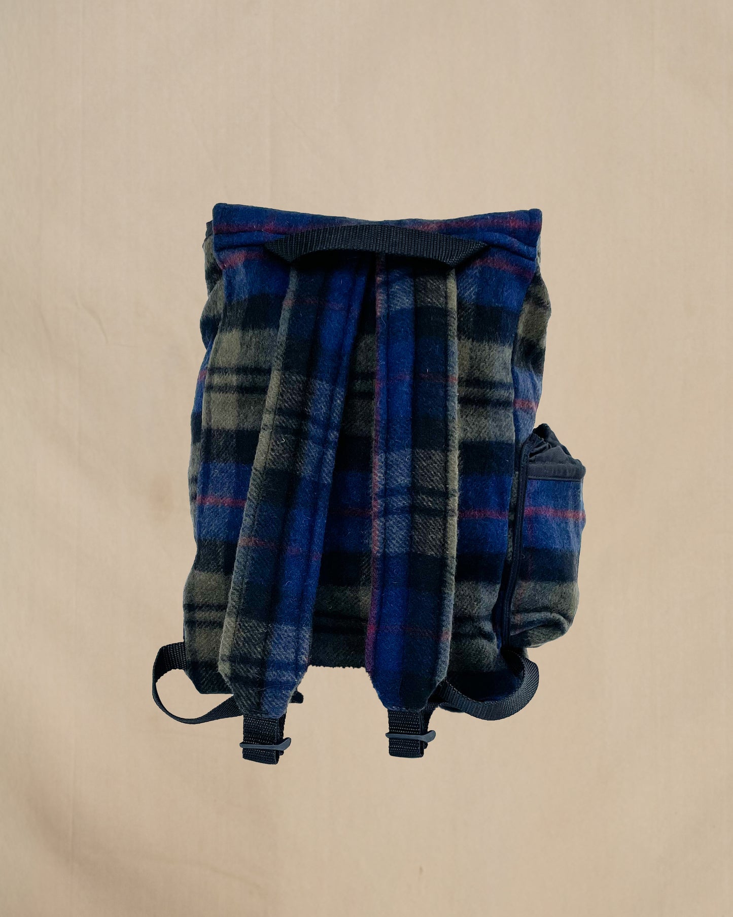 Blue and olive plaid wool backpack with side water bottle pocket, back view