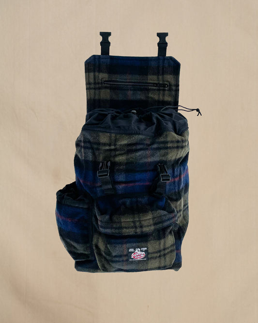 Blue and olive plaid wool backpack with side water bottle pocket, front view