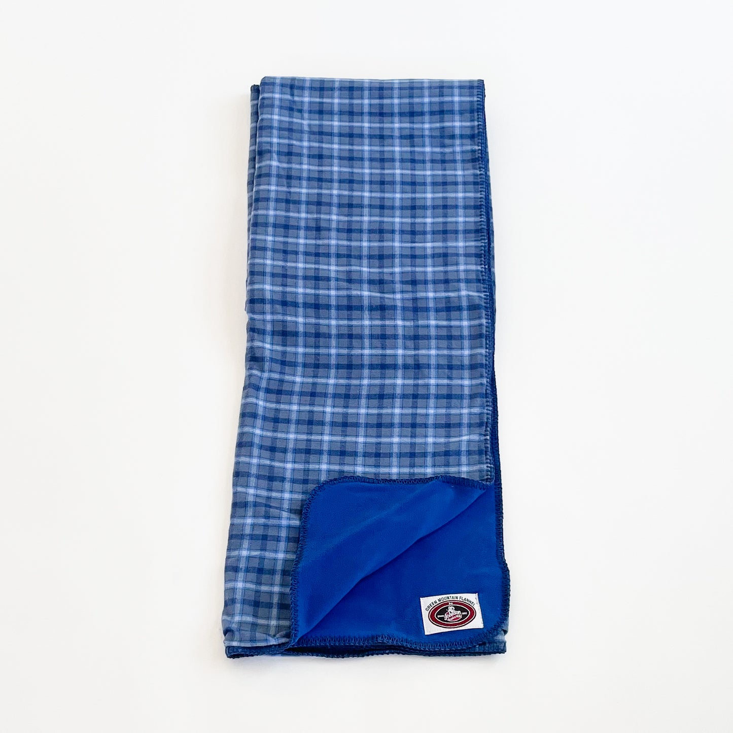 Green Mountain Flannel Throw Bluebird, light blue/dark blue/ white stripes with blue fleece lining open corner view