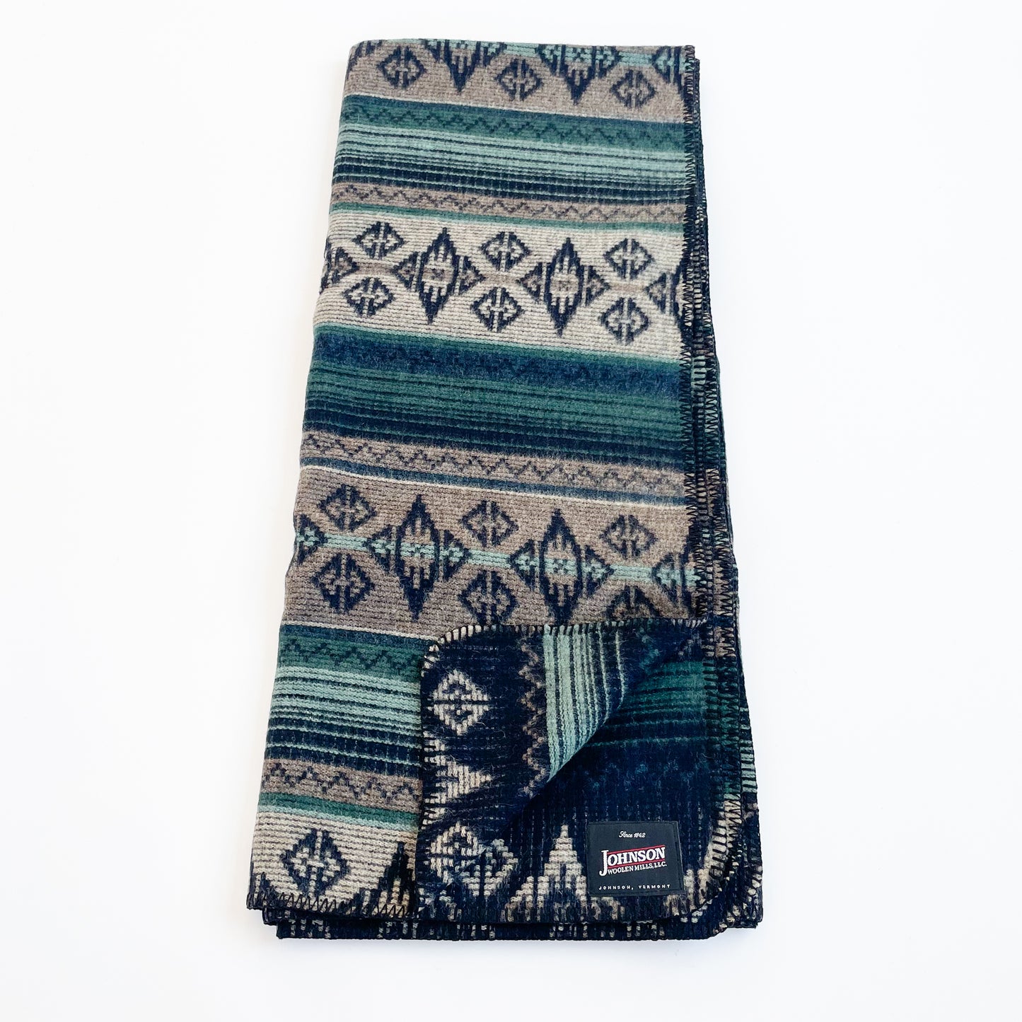 Johnson Woolen Mills Summer Shade Teal Taupe Navy Print folded blanket length wise with logo patch