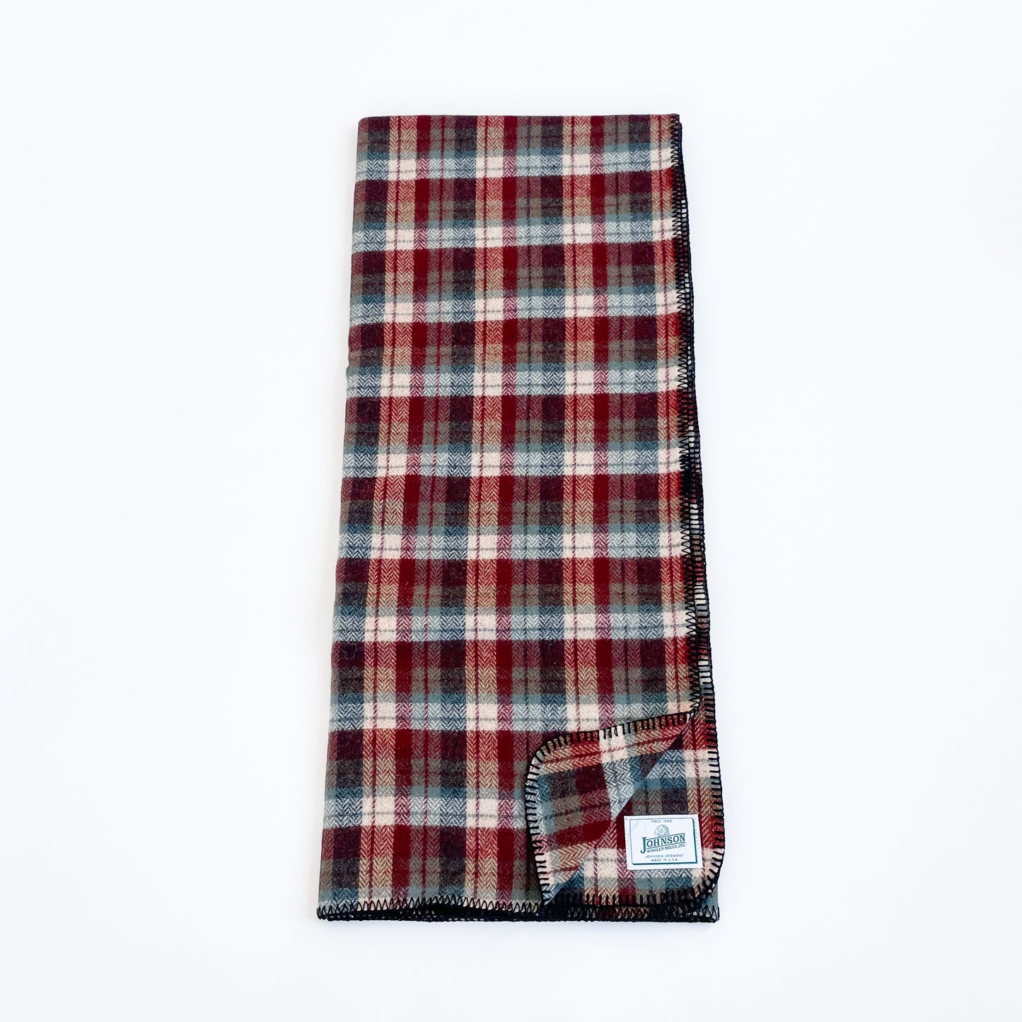 Johnson Woolen Mills Teal Rust Cream Plaid folded folded blanket length wise with logo patch
