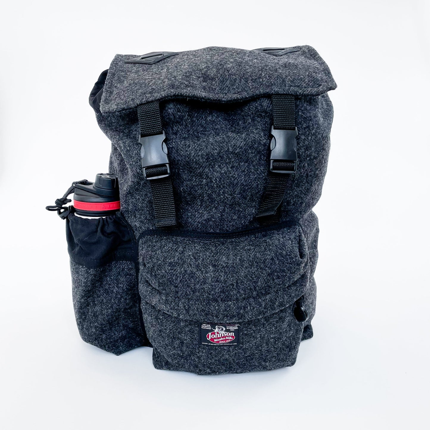 Wool back pack in grey, shown with water bottle in side pocket