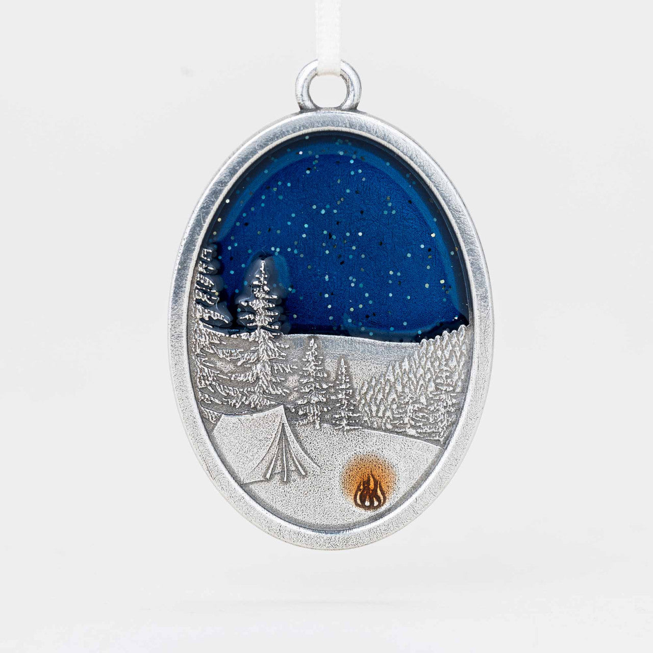Silver pendant with a winter landscape design on a white background