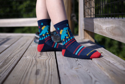Darn Tough Children's 3038 Eclipse Dino sock - black, light blue, yellow and red on model
