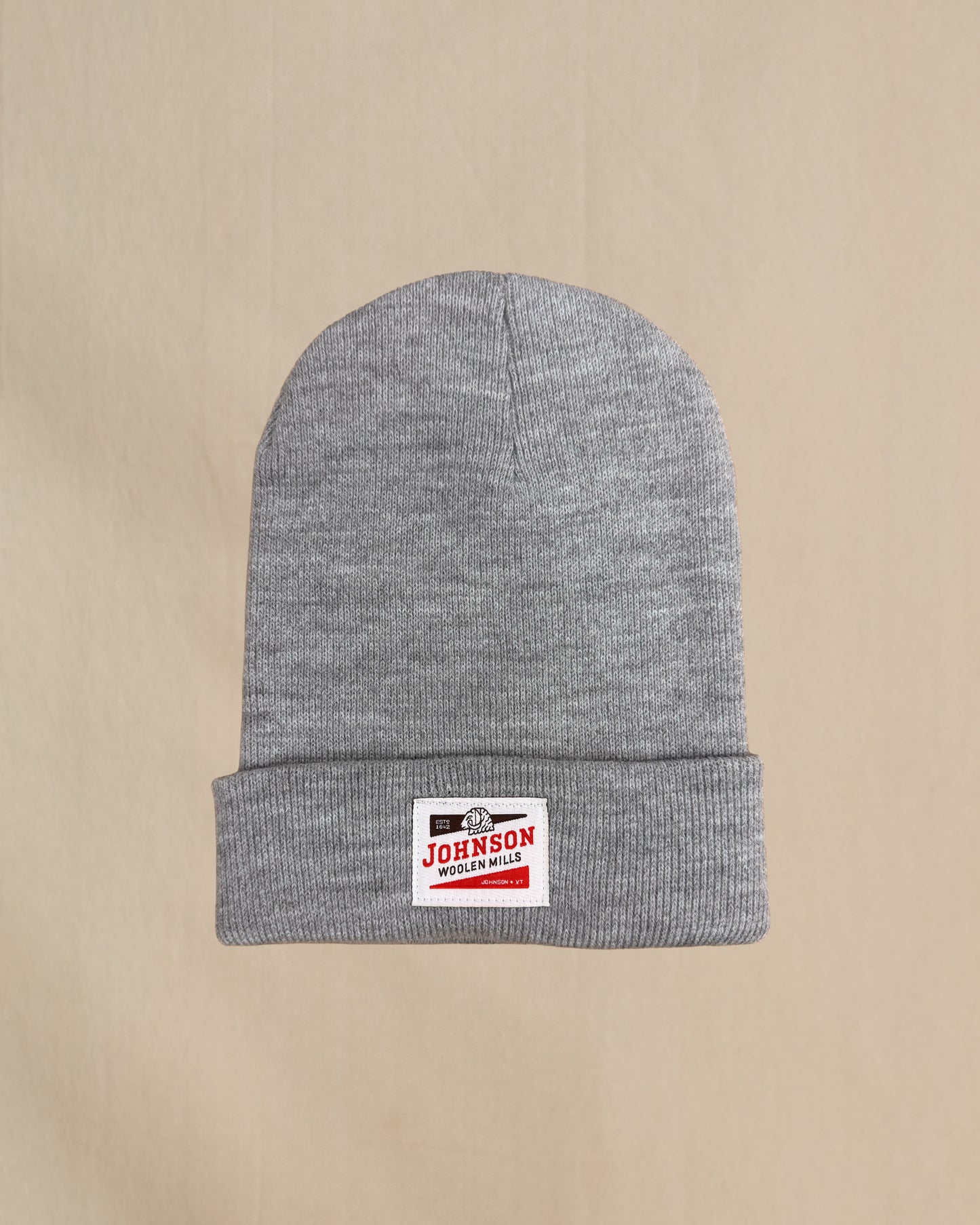 Gray beanie with a Johnson logo on a beige background