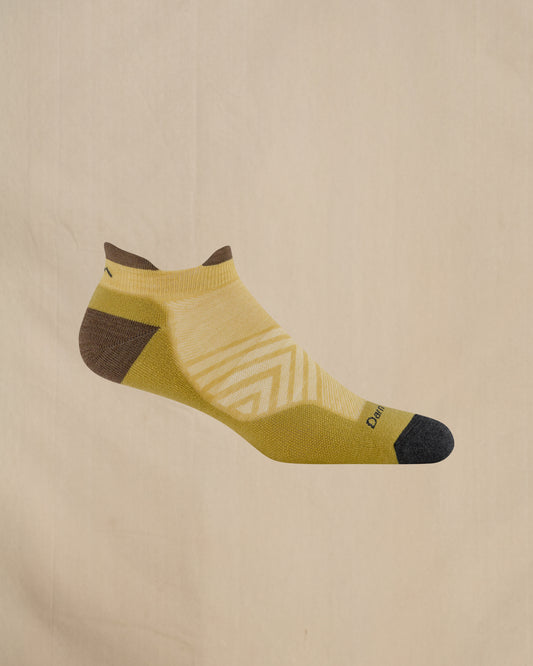 Yellow sock with brown accents on a beige background