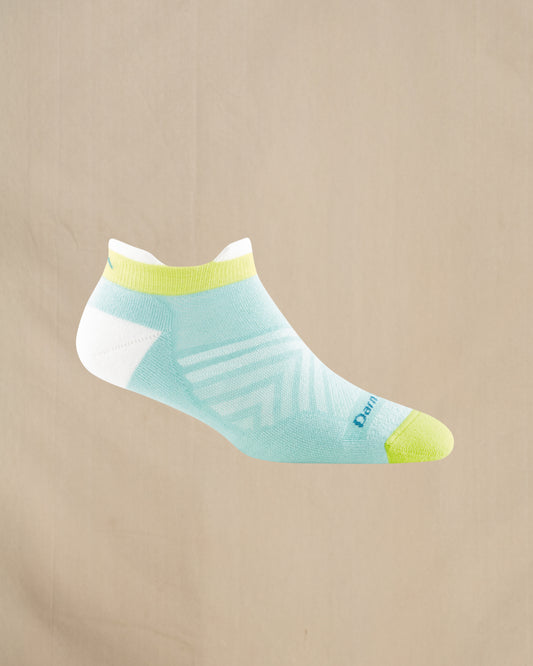 Light blue ankle sock with green accents on a beige background