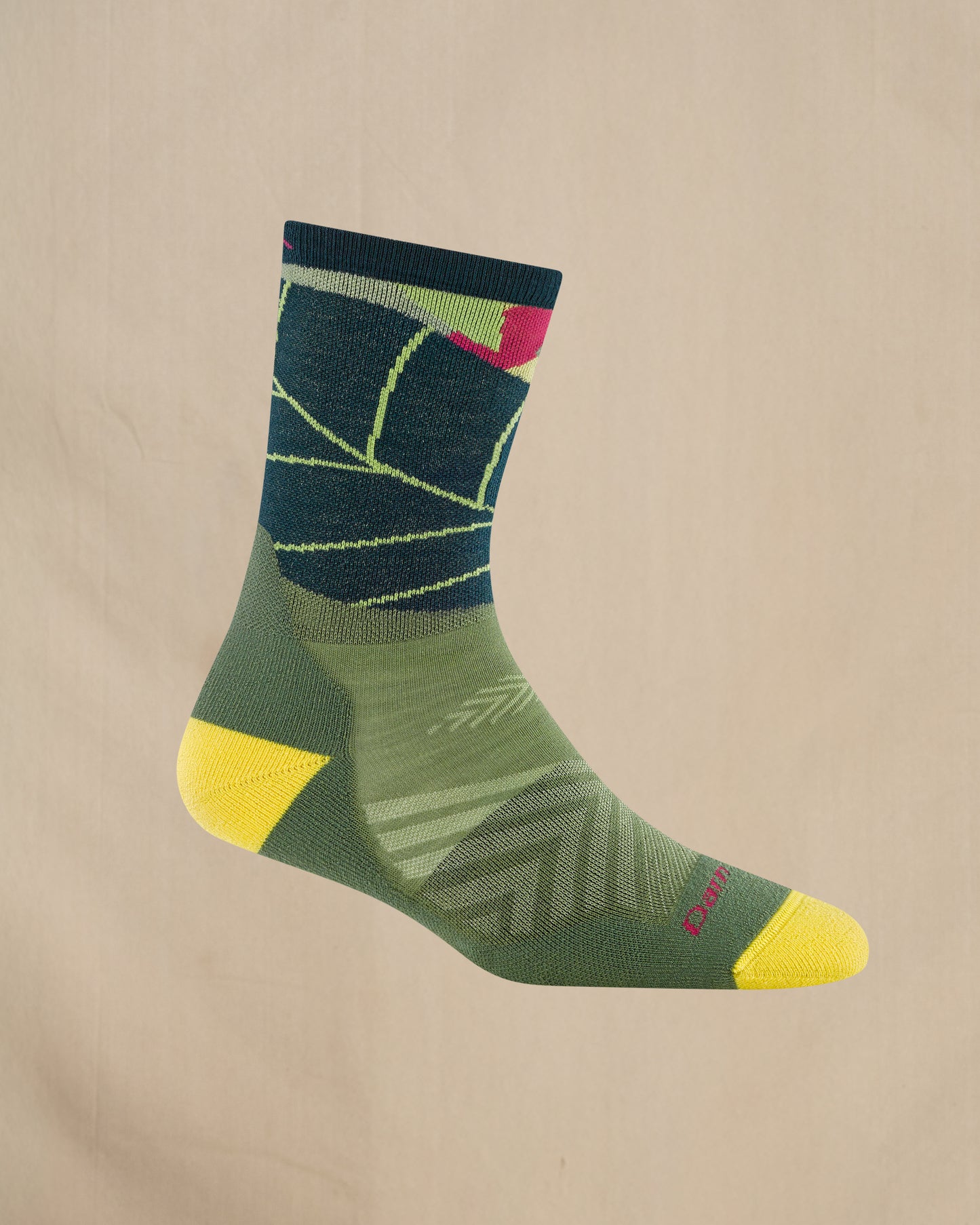Green sock with yellow accents on a beige background