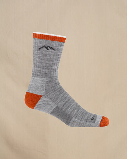 Gray sock with orange accents on a beige background