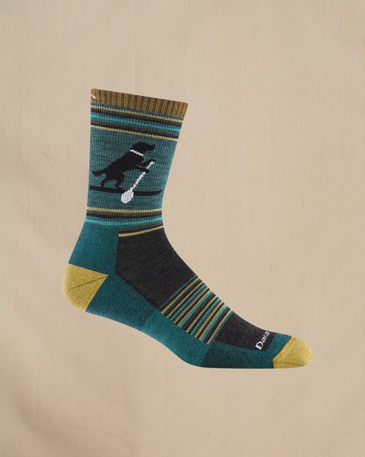 Teal sock with a dog and spoon design on a beige background