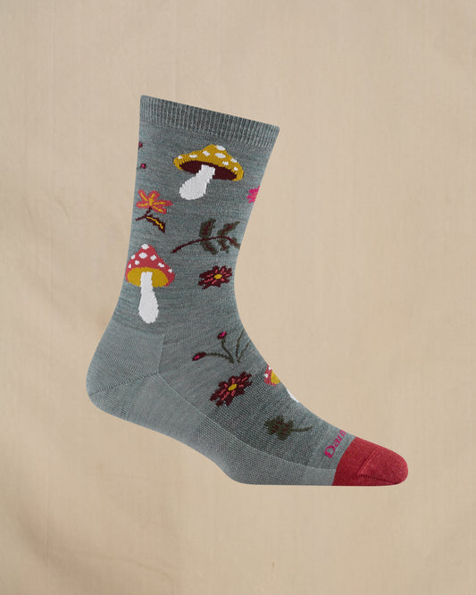 Gray sock with colorful mushroom and flower patterns on a beige background