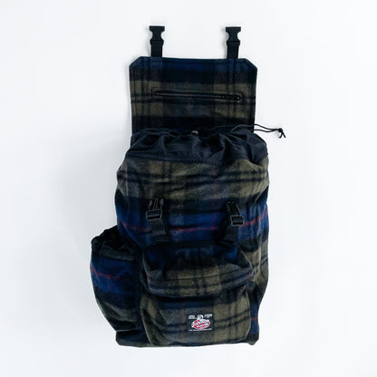 Blue and olive plaid wool backpack with side water bottle pocket, front view