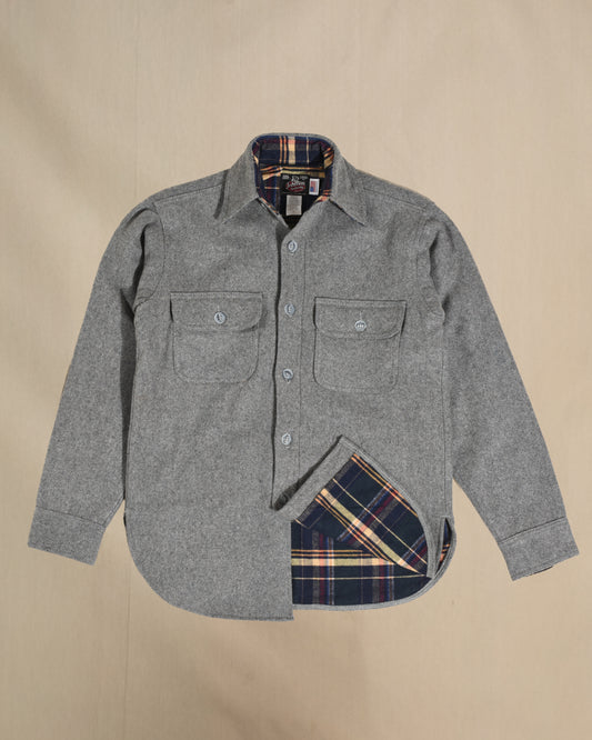 Gray flannel shirt with plaid lining on a beige background