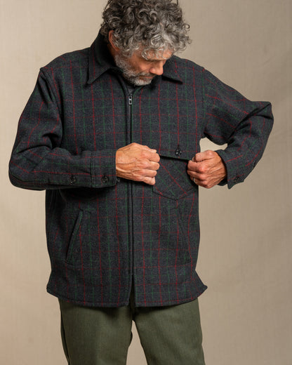 Man wearing a Adirondack plaid wool jacket against a beige background