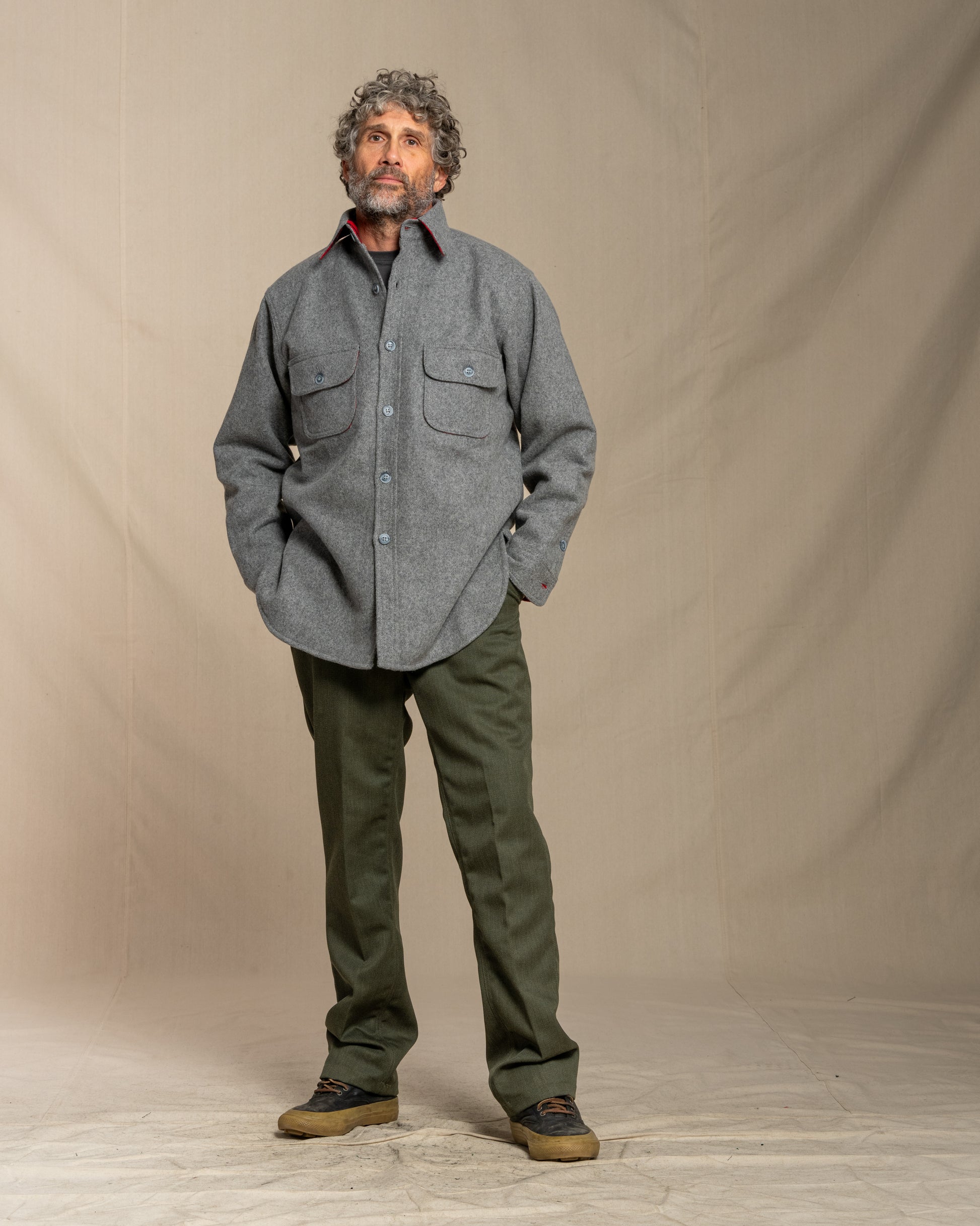 Man wearing a wool gray shirt and green pants