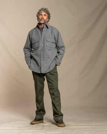 Man wearing a wool gray shirt and green pants