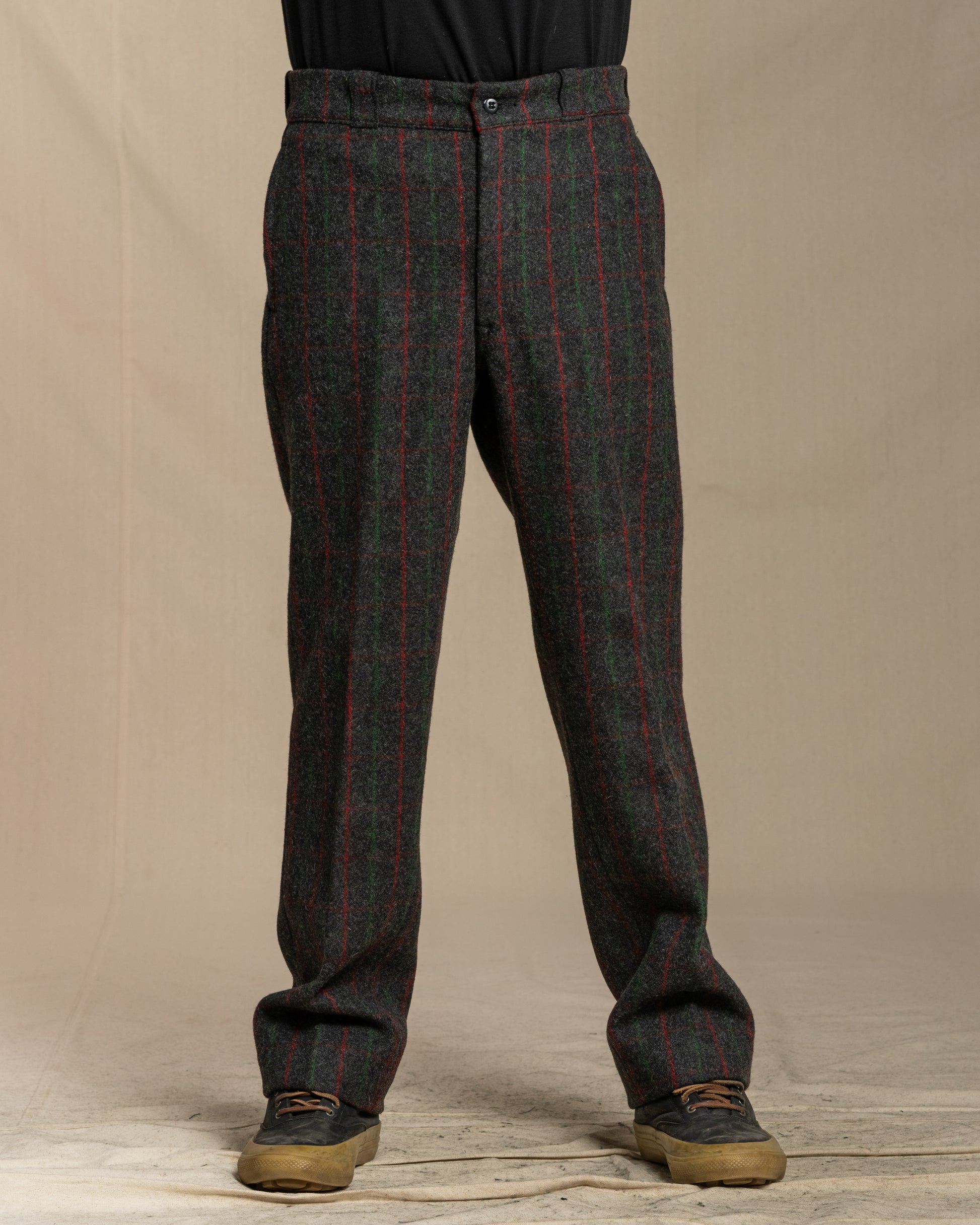 Person wearing Adirondack plaid pants against a beige background