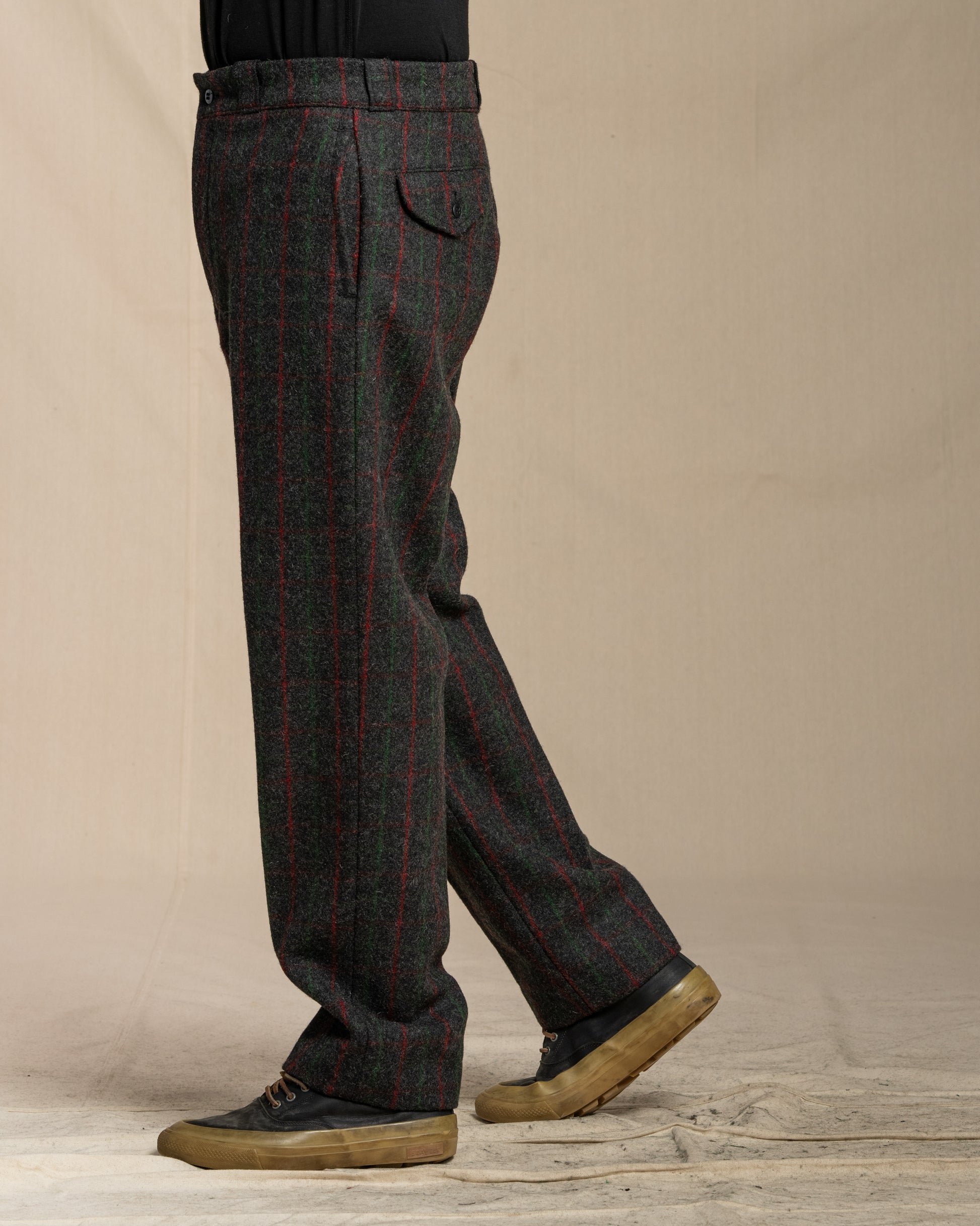 Person wearing Adirondack plaid pants against a beige background