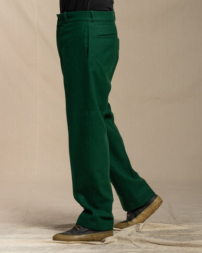 Green wool pants worn by a person on a canvas background