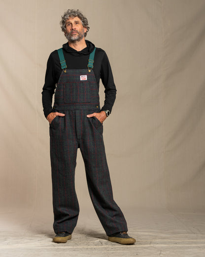 Man wearing Adirondack plaid wool overalls with a plain background