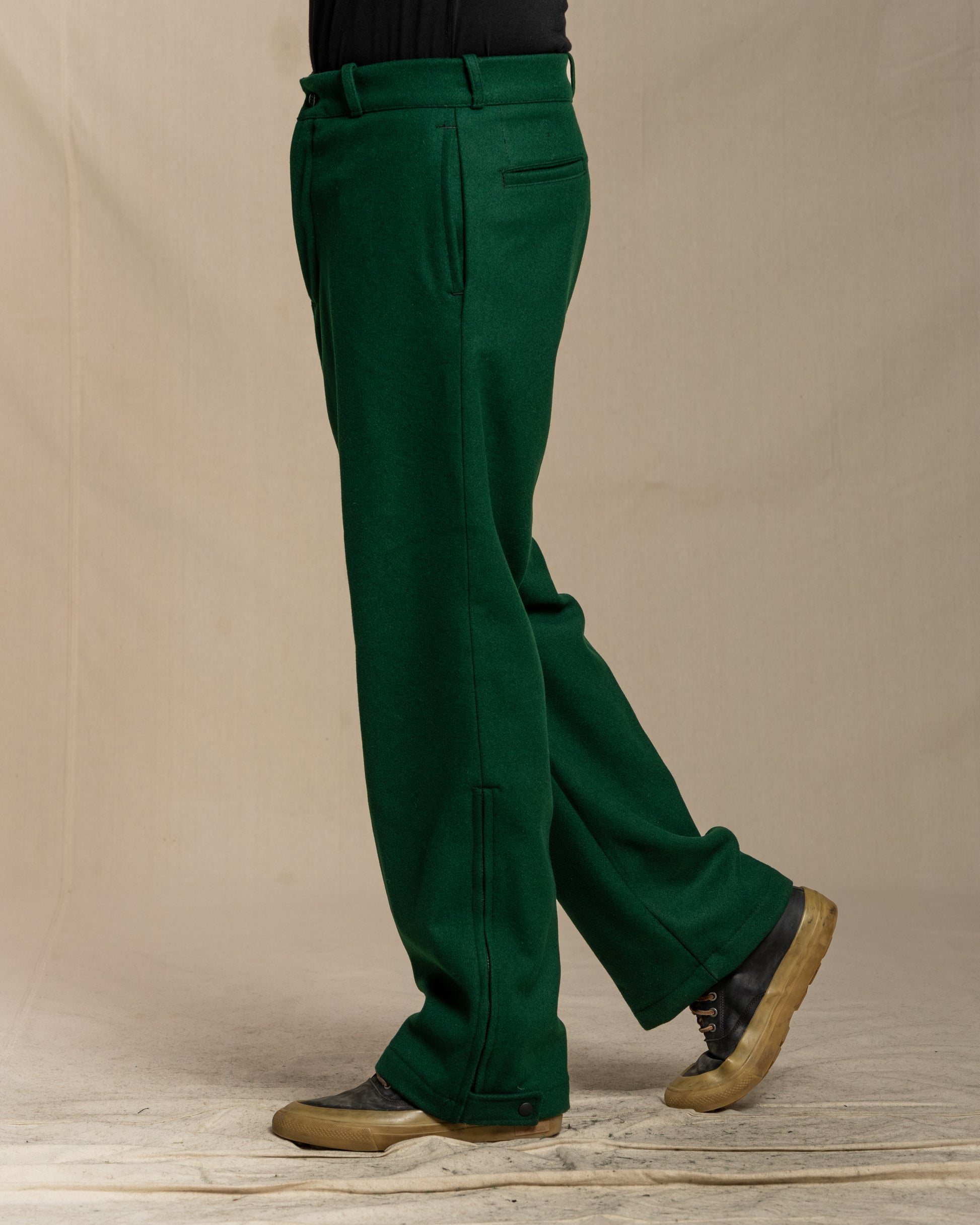 Green wool lined pants with zip and button at ankle