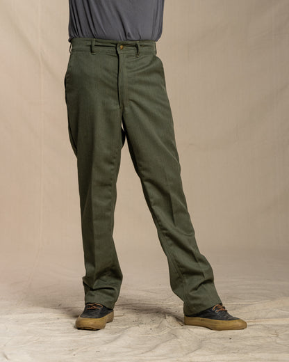 Person wearing green pants on a beige background