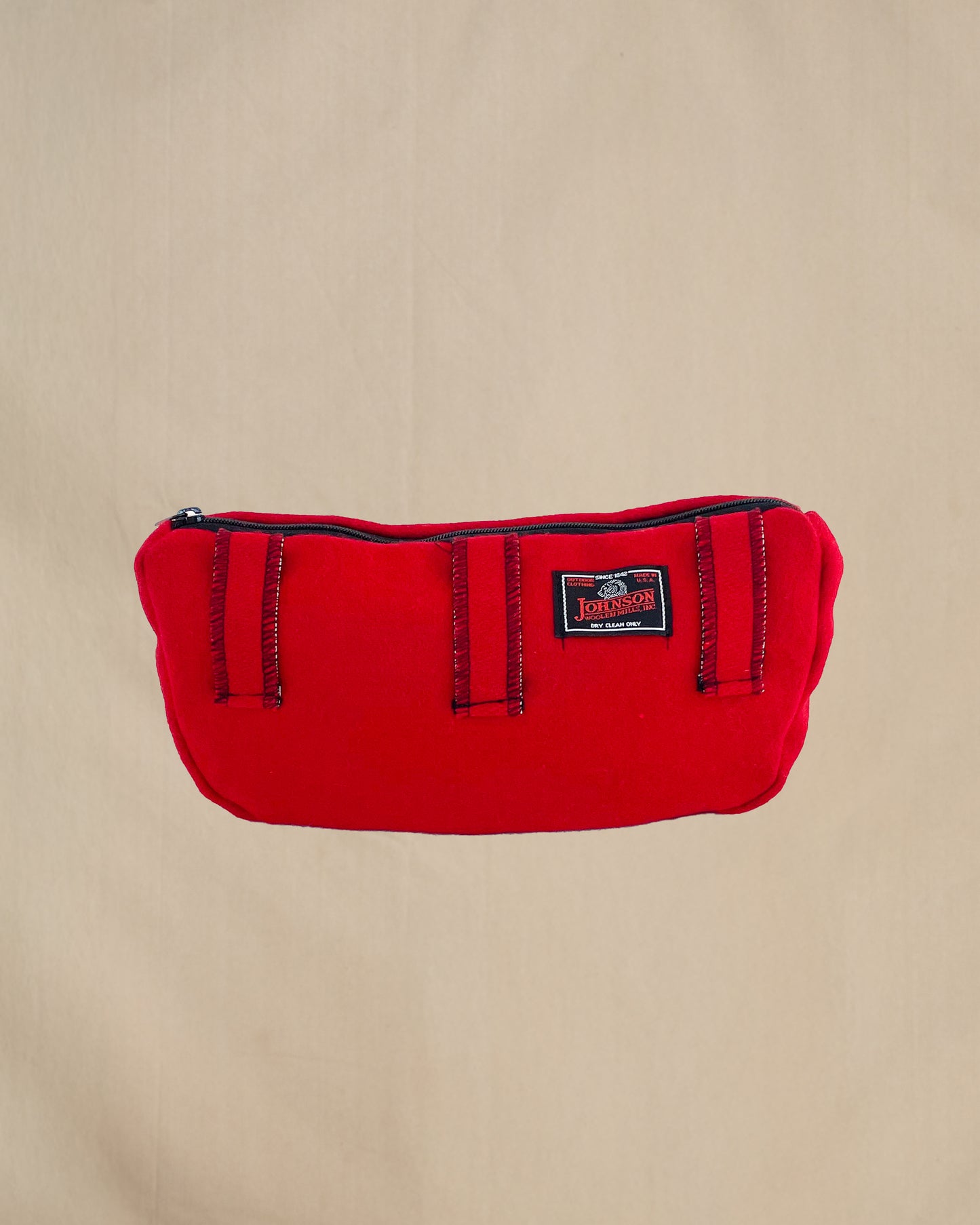 Wool sidewinder - bag with zipped closure and belt loops for wearing on your waist. Shown in scarlett. Back view