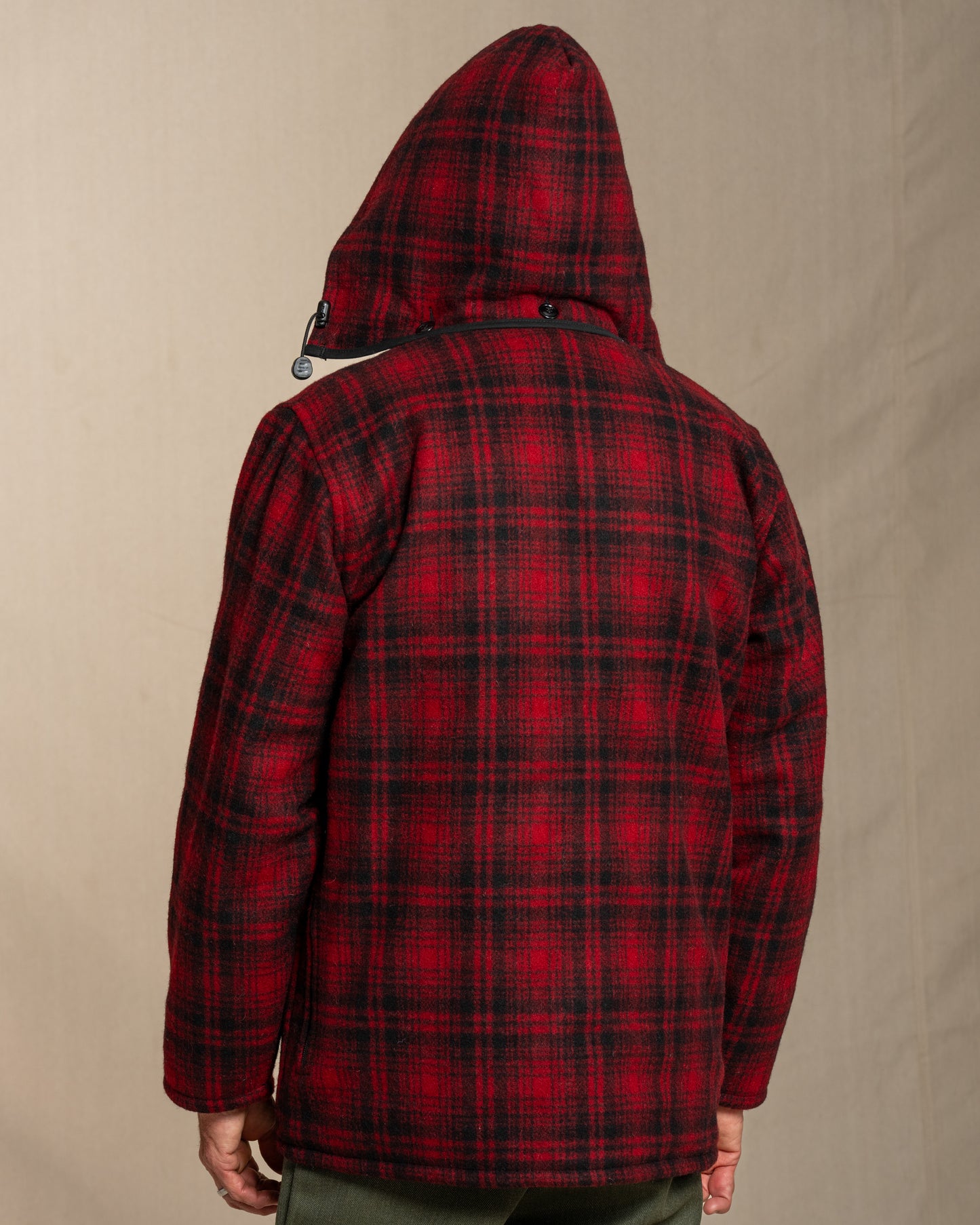 Red and black plaid jacket on a beige background