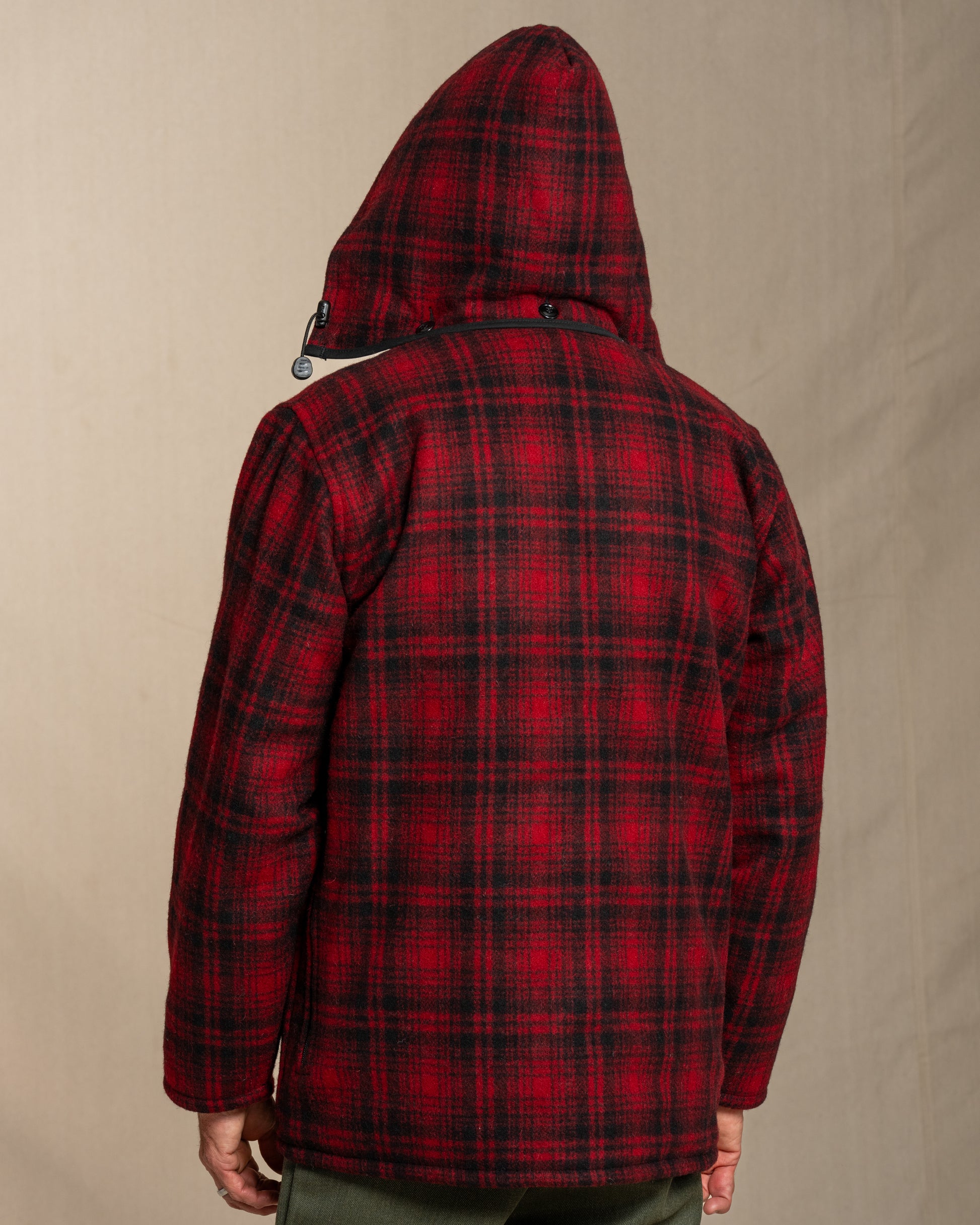 Red and black plaid jacket on a beige background