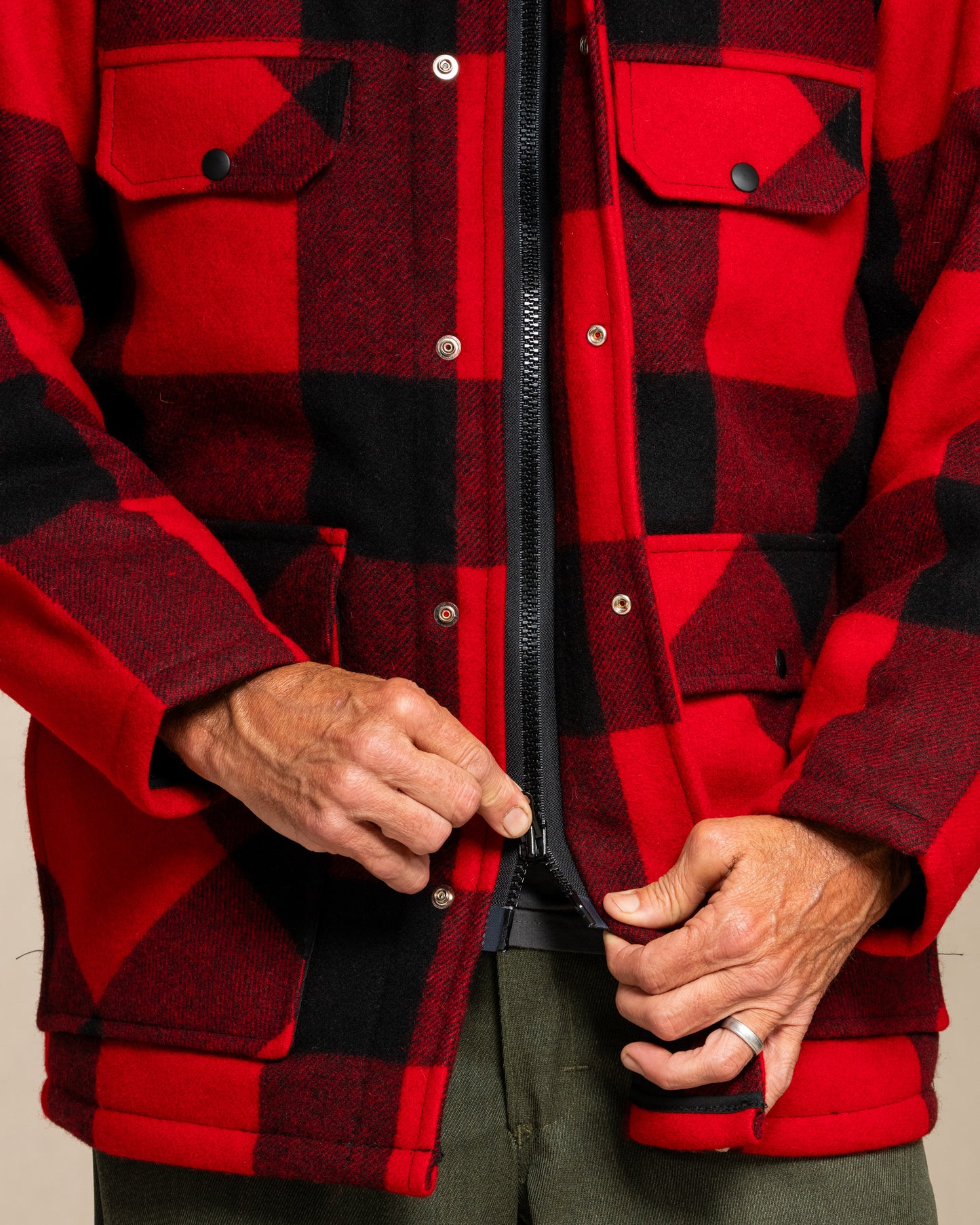 Red and black checkered jacket with a person 2-way zipper.