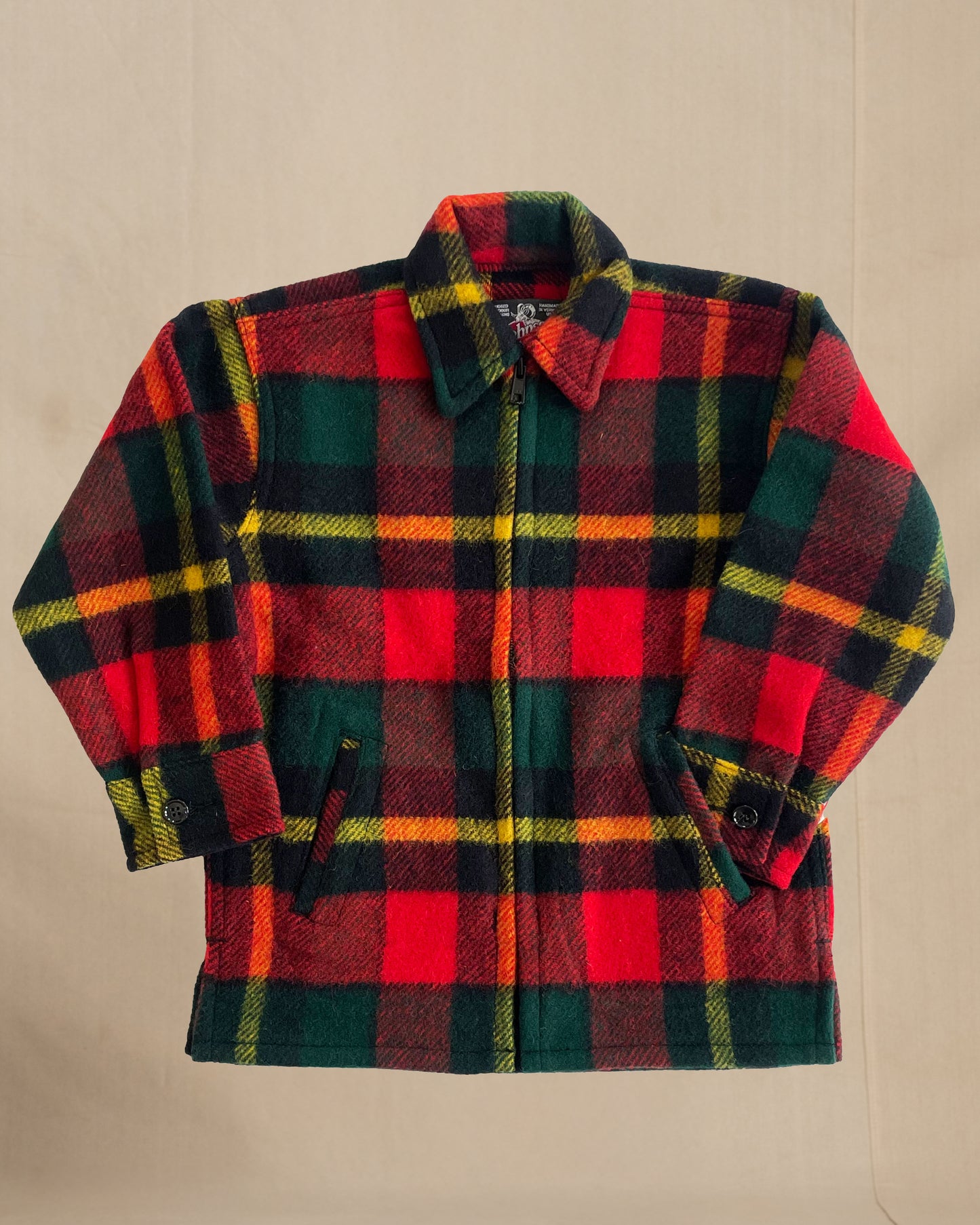 Children's Plaid shirt with red, green, and orange pattern on a beige background