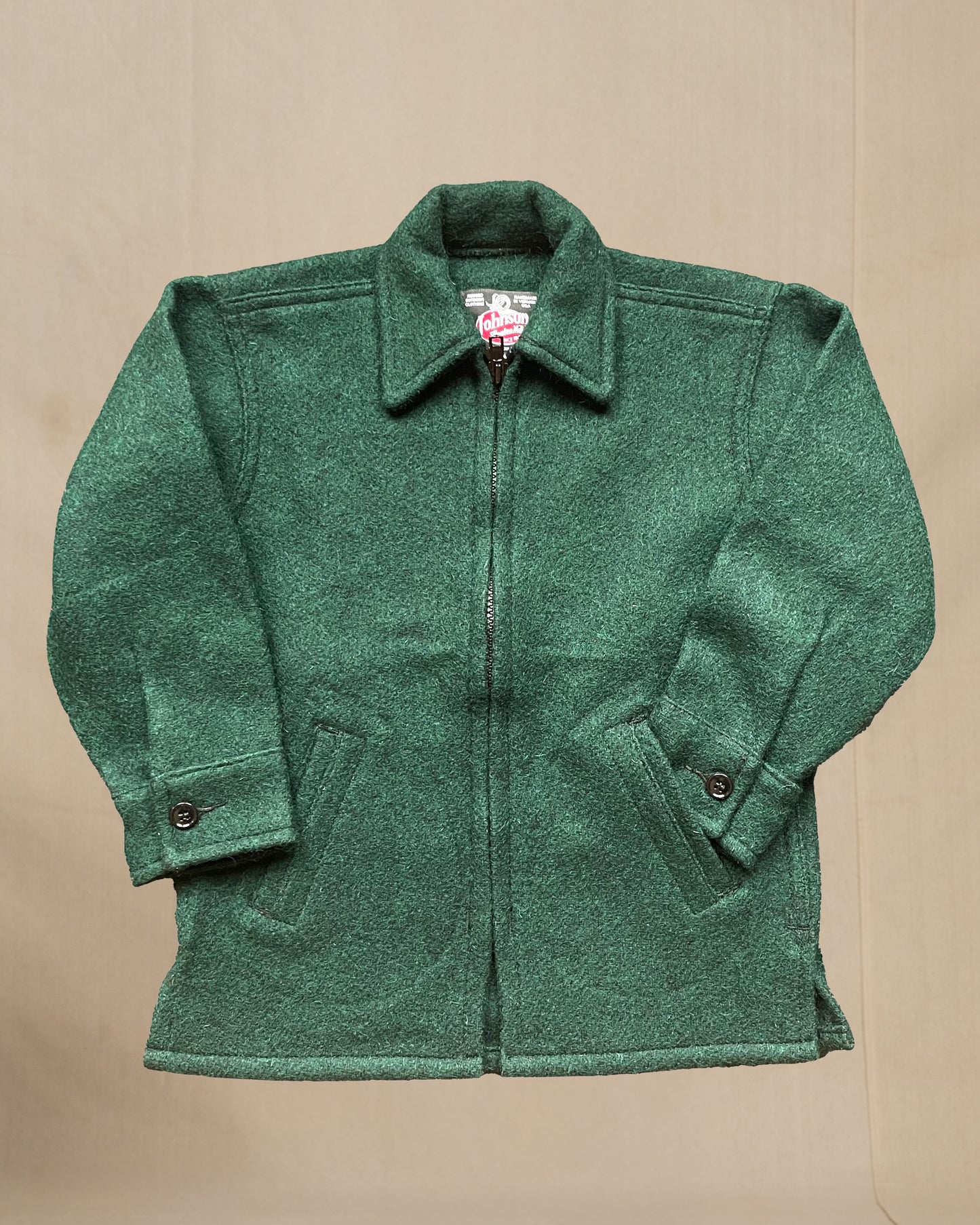 Children's Green jacket on a beige background