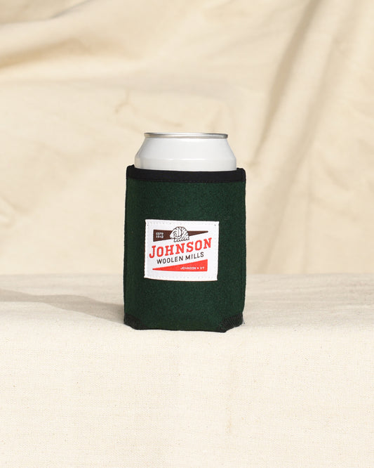 Green wool can cooler with Johnson logo on a beige surface