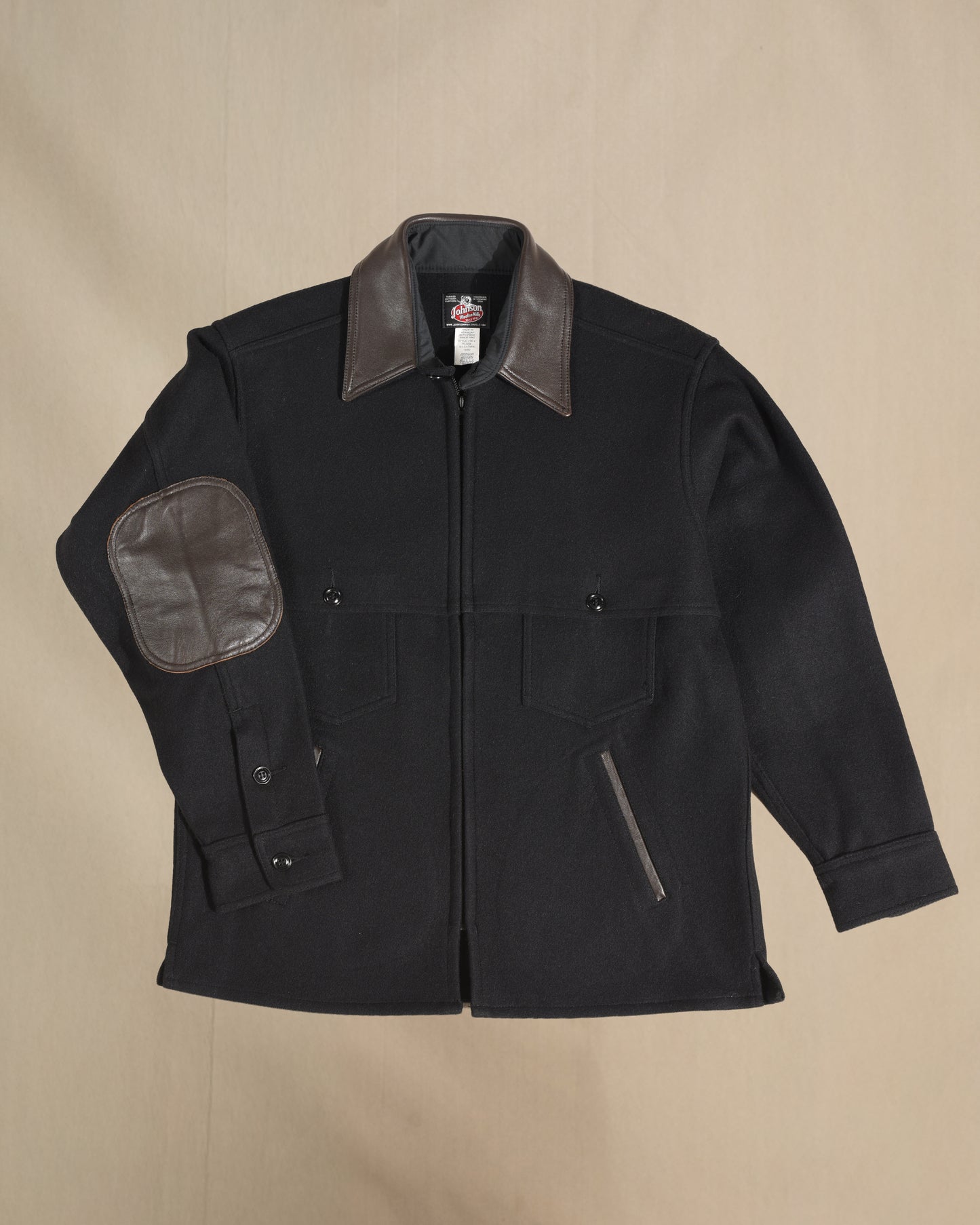 Black wool jac shirt with leather collar, elbow, and pocket detail.  Front view