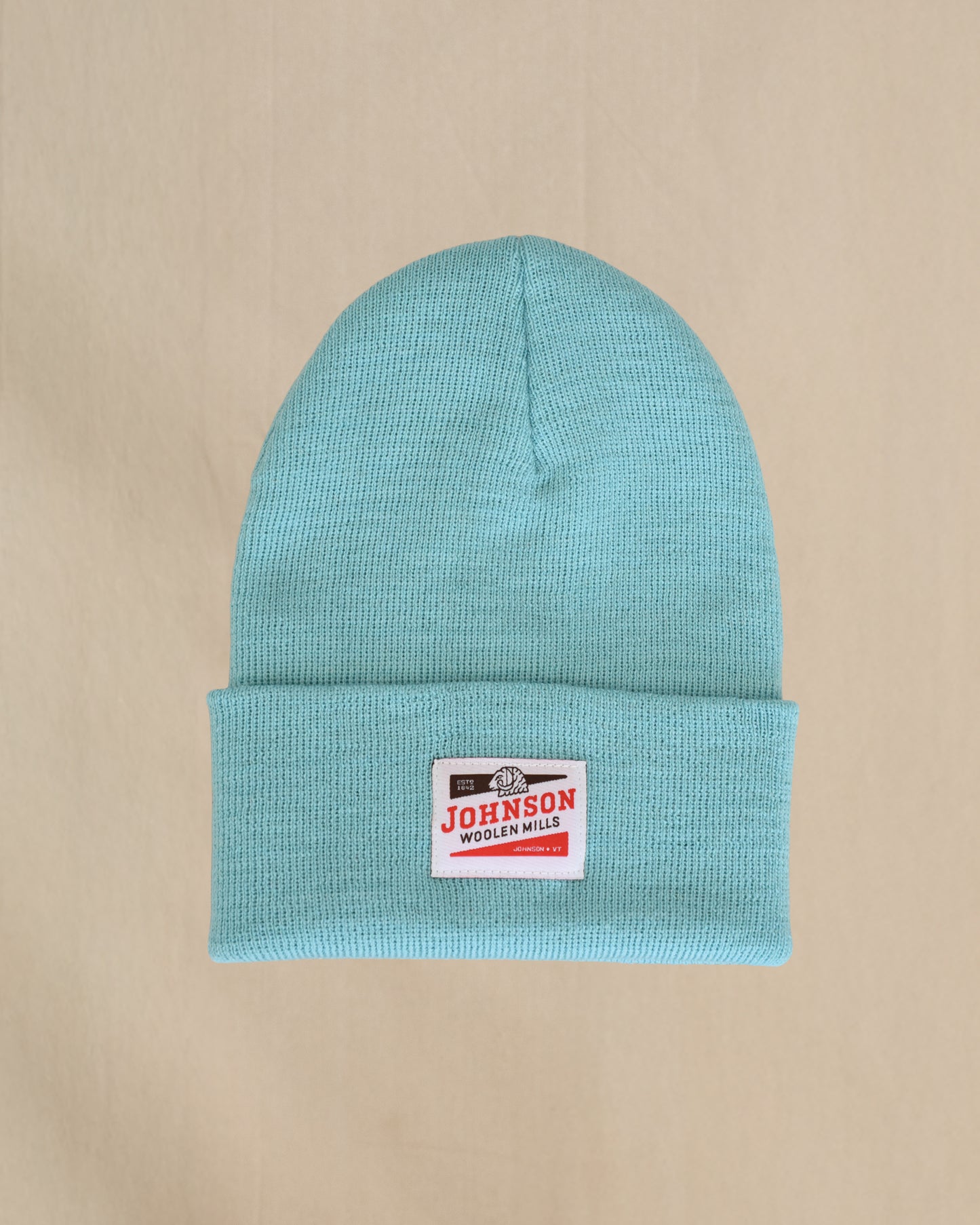 Merino Wool beanie in Canal blue with a Johnson label on a beige background