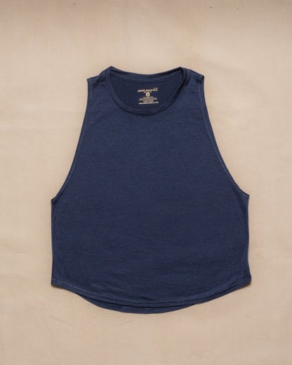 A navy blue sleeveless merino wool tank top laid flat on a light beige background.