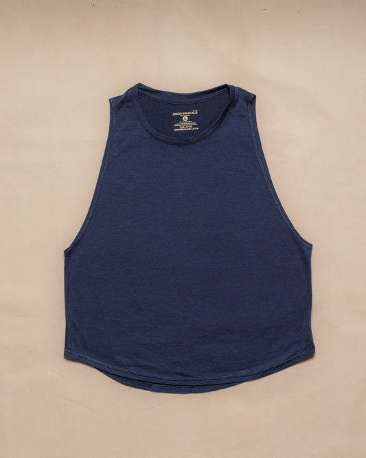 A navy blue sleeveless merino wool tank top laid flat on a light beige background.
