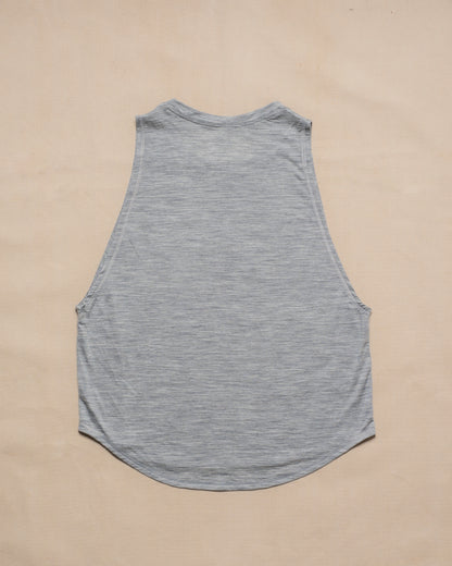 A gray sleeveless merino wool tank top laid flat face down on a light beige background.
