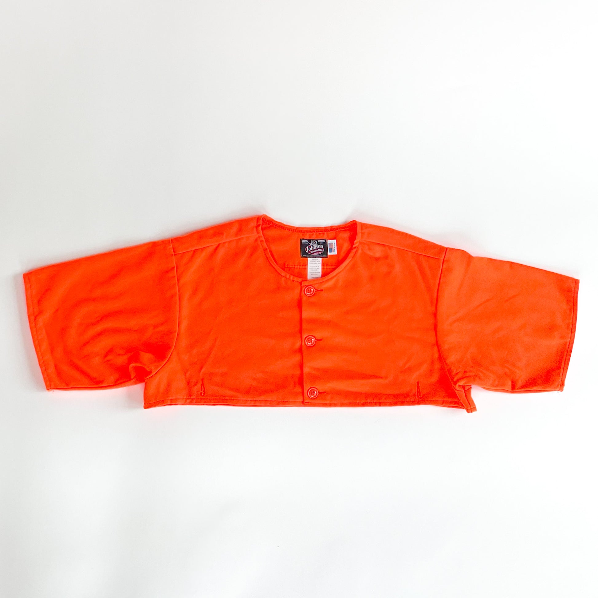 Blaze orange safety cape, designed to work over any Johnson Woolen Mills coat or jacket. Short sleeved, Blaze Orange with three button front & two bottom button holes
