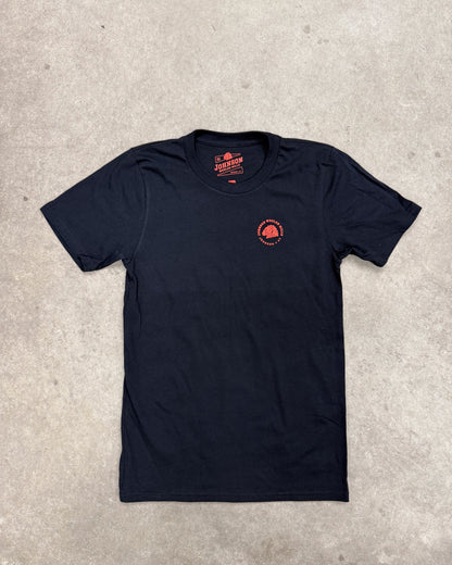 Black t-shirt with a red logo on a gray concrete surface