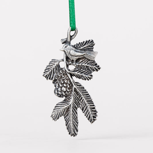 Danforth Pewter Bird on a Bough Carded Ornament. Bird on a branch with leaves and pinecone.