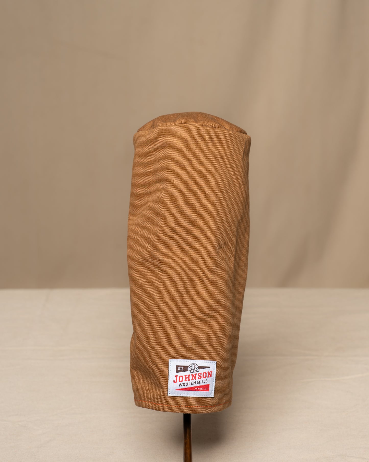 Brown canvas driver headcover with a Johnson logo on a beige background